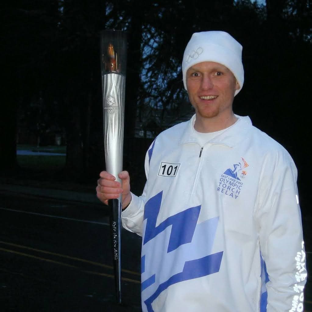 Nathan Spear holding the Olympic torch during the Salt Lake City Olympic Torch Relay